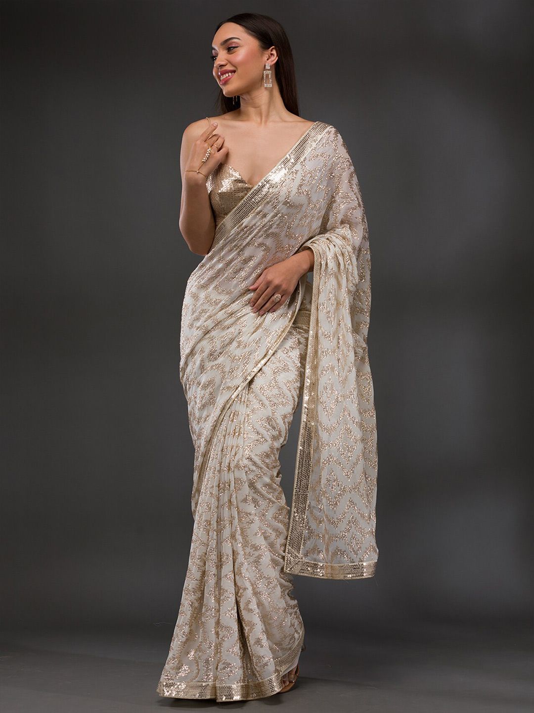 3946f1af-09b9-4afb-8b18-38220f937d521700562703886KoskiiOffWhiteEmbellishedSequinnedPureGeorgetteSaree1.jpg Koskii Embellished Sequinned Pure Georgette Saree - Image 1